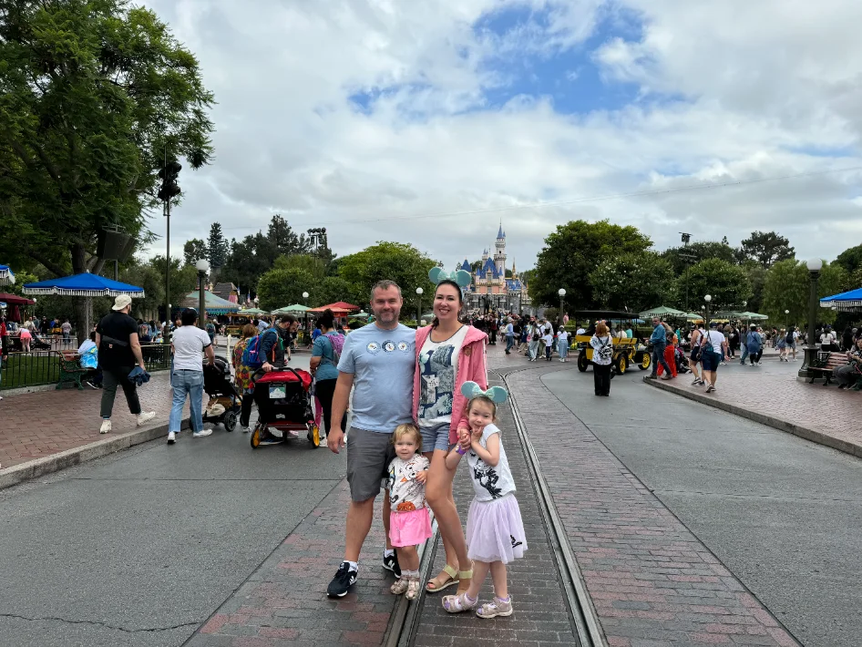 A family walking together on a sunny theme-park day
